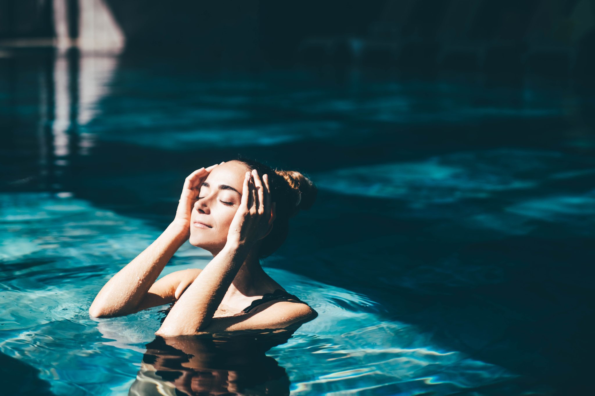 Woman relaxing in the swimming pool.